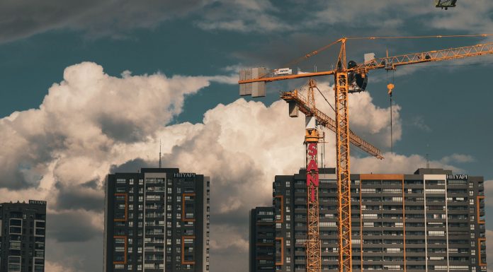 New 6-Story Apartment Building Approved on Pavonia Avenue in Journal Square Construction site in Istanbul with cranes and buildings under a dramatic cloudy sky.