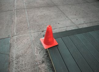 North Bergen expedites roadwork on 6th Street and Columbia Avenue Orange traffic cone placed on a sidewalk edge with wooden planks.