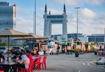 View of lively food truck area near the iconic Terengganu Drawbridge. Perfect for street food enthusiasts.