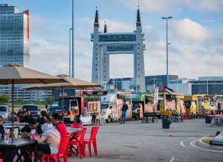 View of lively food truck area near the iconic Terengganu Drawbridge. Perfect for street food enthusiasts.