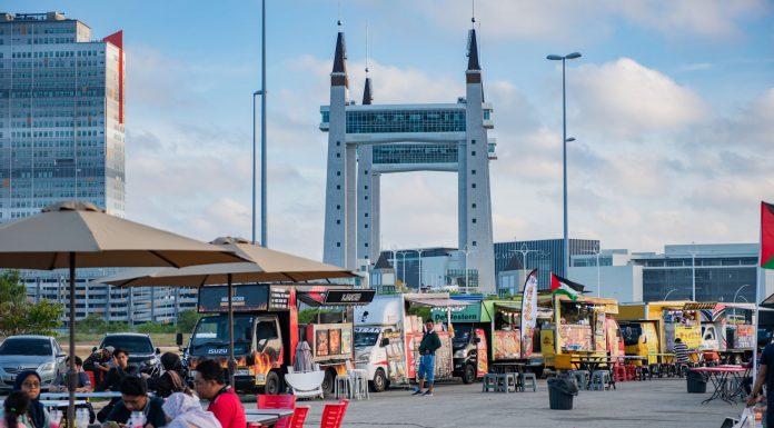 View of lively food truck area near the iconic Terengganu Drawbridge. Perfect for street food enthusiasts.