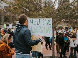 A peace rally in San Francisco with protesters holding signs supporting Ukraine.