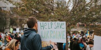 A peace rally in San Francisco with protesters holding signs supporting Ukraine.