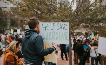 A peace rally in San Francisco with protesters holding signs supporting Ukraine.