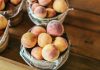 Peach Pie Contest Returns for 13th Year at Jersey City’s Riverview Park A collection of fresh peaches stacked in baskets, highlighting their juicy appeal and rustic setup.