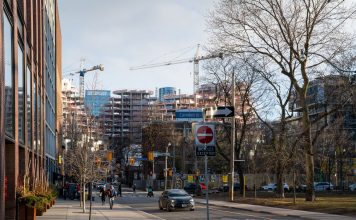 Planning Board Retroactively Denies Approval for Occupied Downtown Condo Urban construction site in downtown Toronto with cranes and modern architecture.