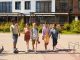 A diverse group of children walking outdoors, symbolizing friendship and multicultural unity.