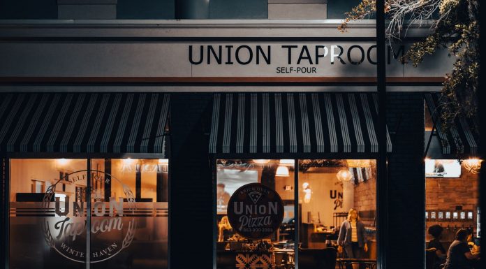 Street view of Union Taproom with warm night lighting and visible patrons inside.
