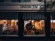 Street view of Union Taproom with warm night lighting and visible patrons inside.