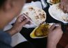Top 10 Best Restaurants in Bayonne, NJ (2026 Guide) Crop anonymous person eating tasty meat with vegetables and pita for dinner in cafe