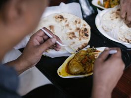 Top 10 Best Restaurants in Bayonne, NJ (2026 Guide) Crop anonymous person eating tasty meat with vegetables and pita for dinner in cafe
