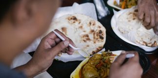 Top 10 Best Restaurants in Bayonne, NJ (2026 Guide) Crop anonymous person eating tasty meat with vegetables and pita for dinner in cafe