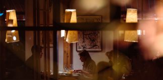 Romantic dining scene in a cozy restaurant with warm lighting and intimate atmosphere.