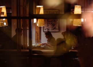 Romantic dining scene in a cozy restaurant with warm lighting and intimate atmosphere.