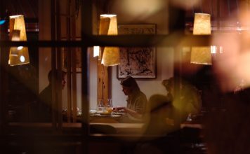 Romantic dining scene in a cozy restaurant with warm lighting and intimate atmosphere.