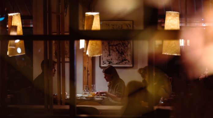 Romantic dining scene in a cozy restaurant with warm lighting and intimate atmosphere.