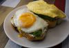 Tasty breakfast with fried egg and avocado on toast, ideal for food lovers.