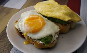 Tasty breakfast with fried egg and avocado on toast, ideal for food lovers.