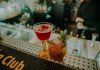 Two vibrant cocktails on a bar counter showcasing a sophisticated nightlife atmosphere.