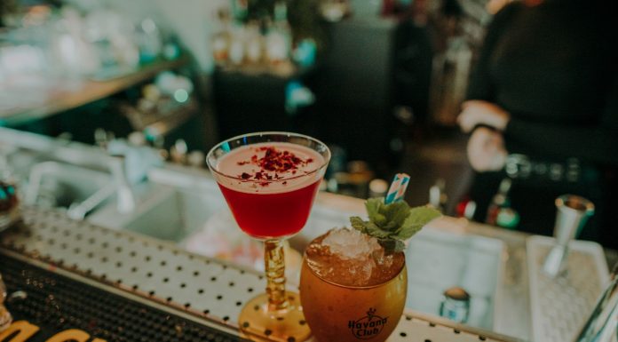 Two vibrant cocktails on a bar counter showcasing a sophisticated nightlife atmosphere.