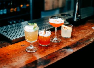 Best Bars in Newark for a Night Out in 2026: Your Local Guide A vibrant selection of cocktails on a wooden bar, perfect for nightlife and parties.