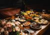 A lavish breakfast spread featuring various dishes elegantly set on a rustic wooden table.
