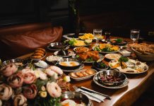 A lavish breakfast spread featuring various dishes elegantly set on a rustic wooden table.