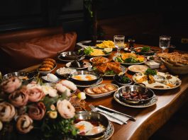 A lavish breakfast spread featuring various dishes elegantly set on a rustic wooden table.