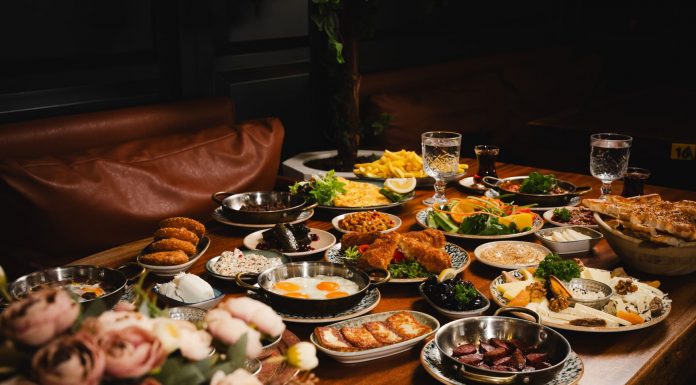 A lavish breakfast spread featuring various dishes elegantly set on a rustic wooden table.