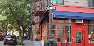 Best Breakfast Spots in West New York, NJ (2026 Local’s Guide) Cozy corner cafe and city street scene in New York with vibrant red facade and sidewalk seating.