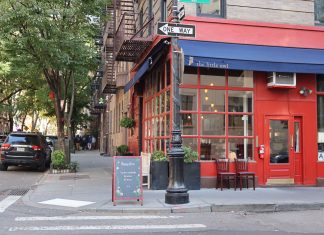 Best Breakfast Spots in West New York, NJ (2026 Local’s Guide) Cozy corner cafe and city street scene in New York with vibrant red facade and sidewalk seating.