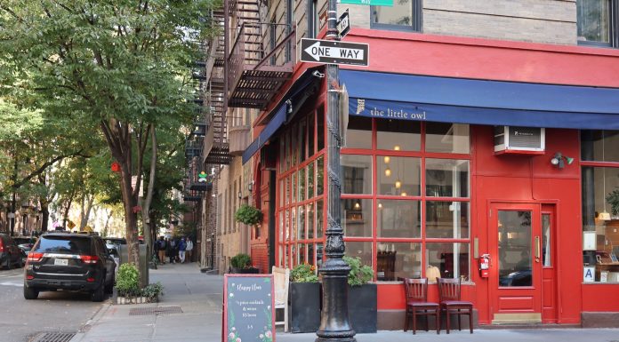 Best Breakfast Spots in West New York, NJ (2026 Local’s Guide) Cozy corner cafe and city street scene in New York with vibrant red facade and sidewalk seating.