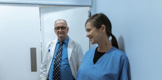 Doctors and nurses interacting in a hospital hallway, showcasing teamwork and professionalism.