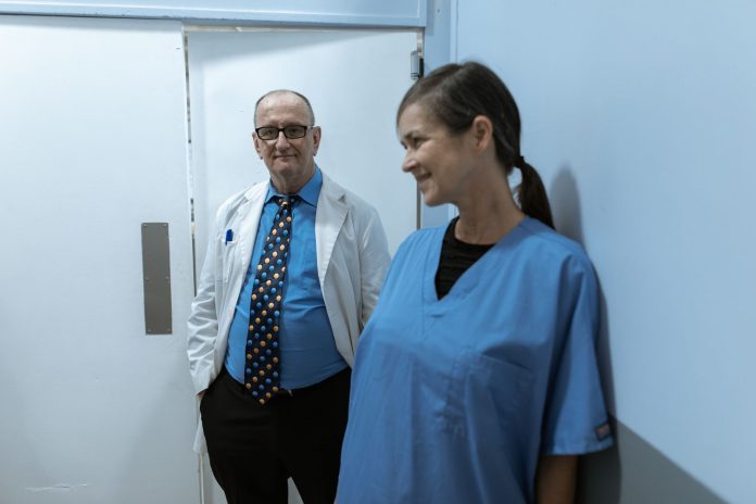 best-doctors-clinics-elizabeth-nj-2026 Doctors and nurses interacting in a hospital hallway, showcasing teamwork and professionalism.