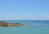 Tranquil seascape of Puerto Plata's coastline with clear skies and turquoise waters.