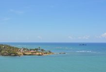 Tranquil seascape of Puerto Plata's coastline with clear skies and turquoise waters.