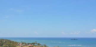 Tranquil seascape of Puerto Plata's coastline with clear skies and turquoise waters.