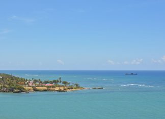 Tranquil seascape of Puerto Plata's coastline with clear skies and turquoise waters.