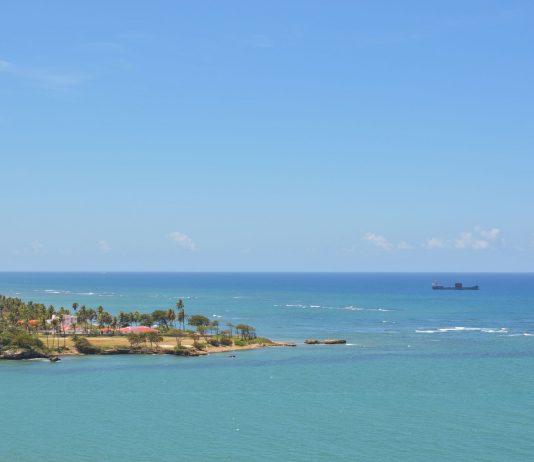 Tranquil seascape of Puerto Plata's coastline with clear skies and turquoise waters.