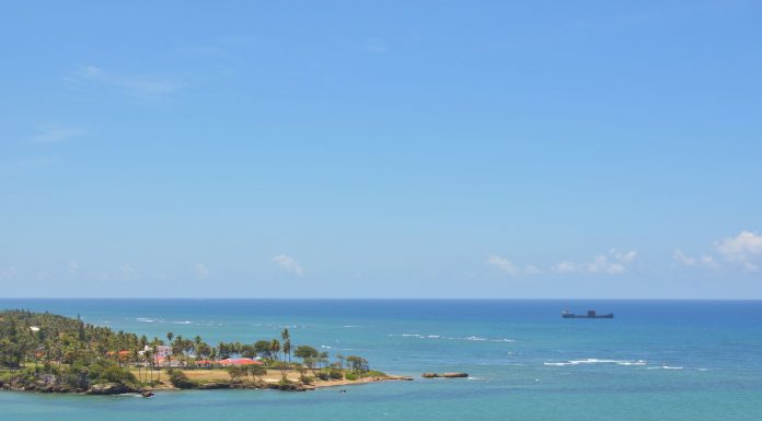 Tranquil seascape of Puerto Plata's coastline with clear skies and turquoise waters.