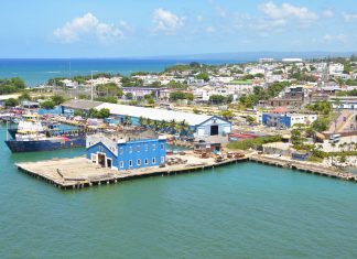 Aerial view of Puerto Plata harbor with blue buildings, ships, and a coastal town in the Dominican Republic.