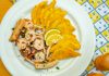 A vibrant plate of seafood and crispy plantains garnished with lemon slices, ready to savor.