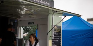 Best Food Trucks in Newark: A 2026 Guide to the City’s Hottest Mobile Eats A food truck with staff serving at an outdoor festival with colorful tents.