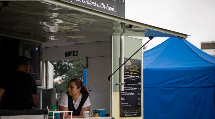 Best Food Trucks in Newark: A 2026 Guide to the City’s Hottest Mobile Eats A food truck with staff serving at an outdoor festival with colorful tents.