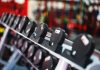 Close-up view of dumbbells in a modern gym setting, emphasizing fitness and training.