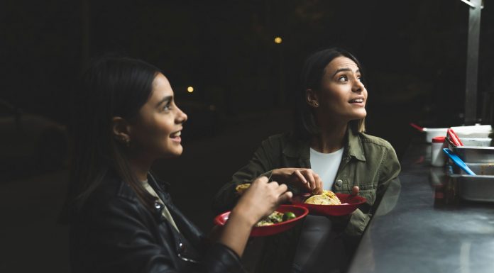 Best Late Night Food in North Bergen (2026 Guide): 12 Spots to Satisfy Your Cravings Two women joyfully ordering tacos at a vibrant nighttime street stand.