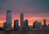 Best Neighborhoods to Live in Newark (2026 Guide) Stunning view of New York City skyline with a vibrant sunset reflecting on skyscrapers.
