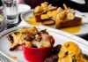 Close-up of delicious eggs benedict and banana topping toast served in Montreal cafe.