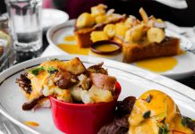 Close-up of delicious eggs benedict and banana topping toast served in Montreal cafe.