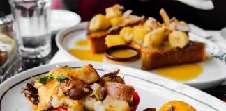 Close-up of delicious eggs benedict and banana topping toast served in Montreal cafe.